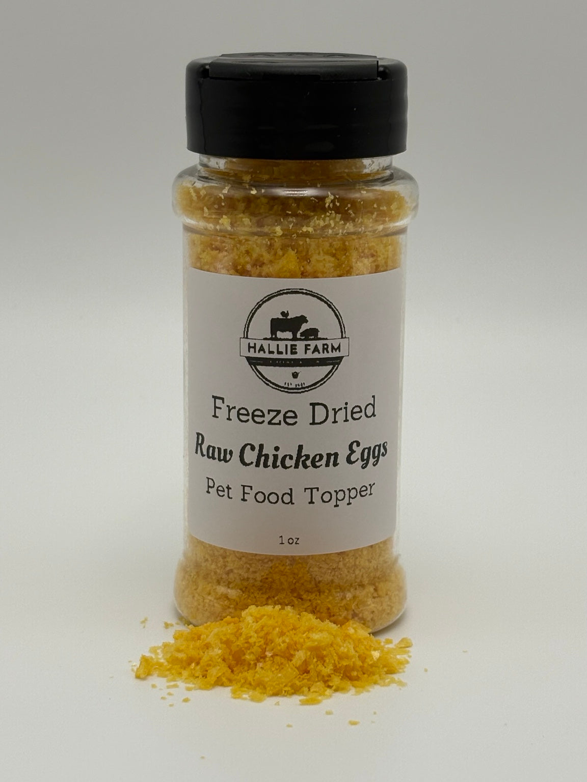 Hallie Farm 1 oz freeze-dried chicken egg pet food topper with golden flakes in front