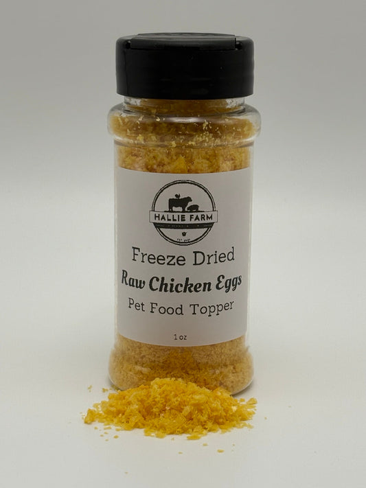 Hallie Farm 1 oz freeze-dried chicken egg pet food topper with golden flakes in front