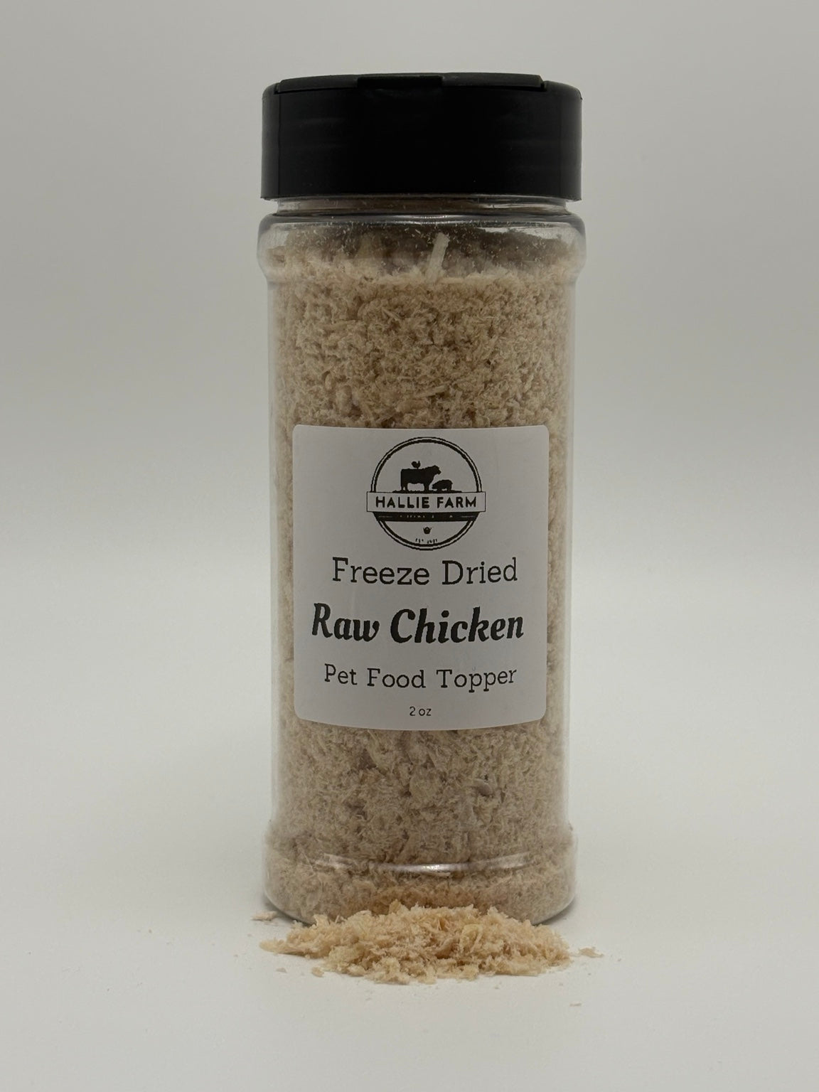 Hallie Farm 2 oz freeze-dried chicken pet food topper jar with loose shredded chicken topper in front