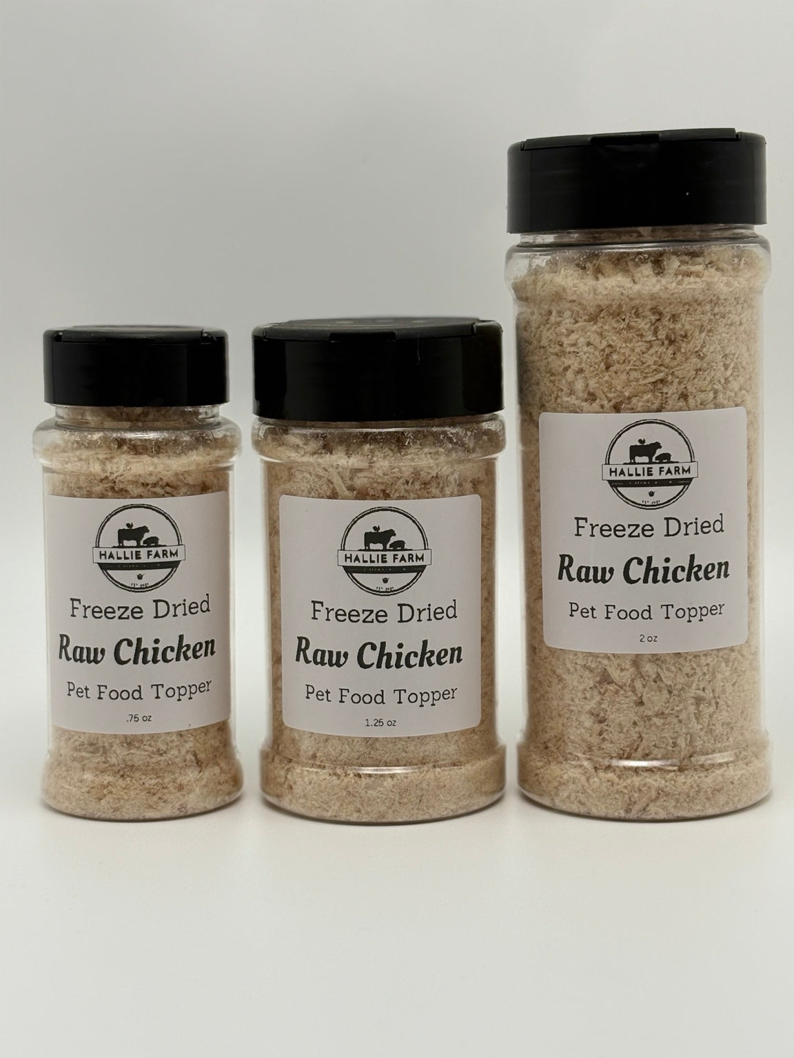 Hallie Farm freeze-dried raw chicken topper jars side by side in 0.75 oz, 1.25 oz and 2 oz sizes